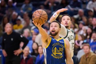 Jan 7, 2026; San Francisco, California, USA; Golden State Warriors guard Stephen Curry (30) shoots the ball against Milwaukee Bucks guard Ryan Rollins (13) during the fourth quarter at Chase Center. Mandatory Credit: Robert Edwards-Imagn Images
