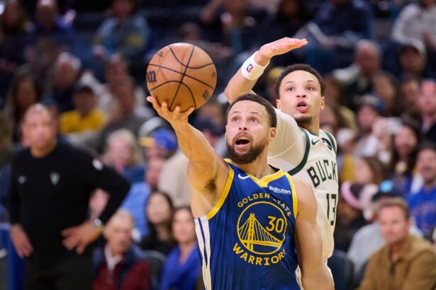Jan 7, 2026; San Francisco, California, USA; Golden State Warriors guard Stephen Curry (30) shoots the ball against Milwaukee Bucks guard Ryan Rollins (13) during the fourth quarter at Chase Center. Mandatory Credit: Robert Edwards-Imagn Images