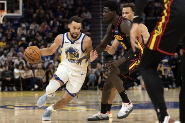 Jan 11, 2026; San Francisco, California, USA; Golden State Warriors guard Stephen Curry (30) drives around Atlanta Hawks forward Mouhamed Gueye (18) during the third quarter at Chase Center. Mandatory Credit: D. Ross Cameron-Imagn Images