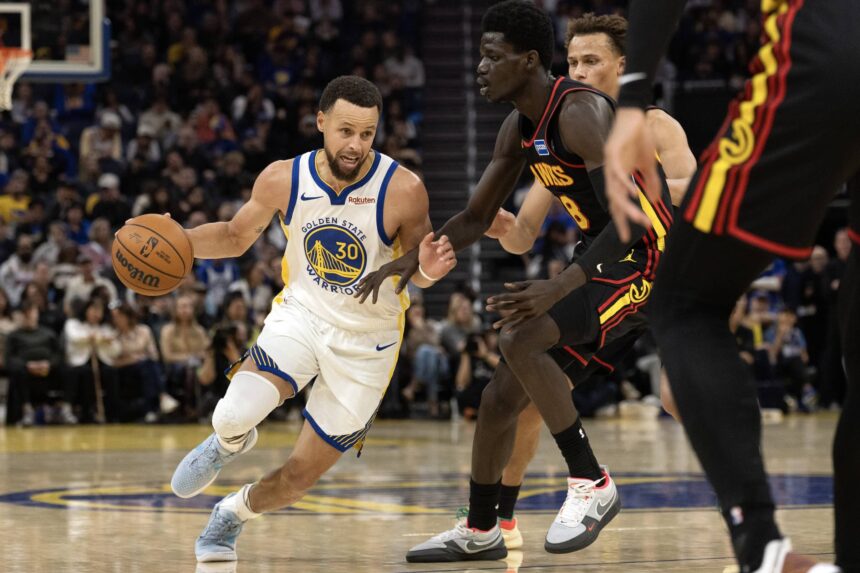 Jan 11, 2026; San Francisco, California, USA; Golden State Warriors guard Stephen Curry (30) drives around Atlanta Hawks forward Mouhamed Gueye (18) during the third quarter at Chase Center. Mandatory Credit: D. Ross Cameron-Imagn Images