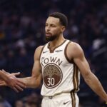 Jan 9, 2026; San Francisco, California, USA; Golden State Warriors guard Stephen Curry (30) high fives a teammate between plays against the Sacramento Kings during the first quarter at Chase Center. Mandatory Credit: Kelley L Cox-Imagn Images