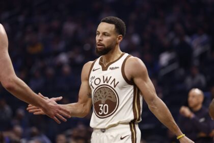 Jan 9, 2026; San Francisco, California, USA; Golden State Warriors guard Stephen Curry (30) high fives a teammate between plays against the Sacramento Kings during the first quarter at Chase Center. Mandatory Credit: Kelley L Cox-Imagn Images