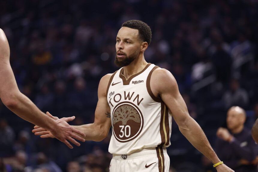Jan 9, 2026; San Francisco, California, USA; Golden State Warriors guard Stephen Curry (30) high fives a teammate between plays against the Sacramento Kings during the first quarter at Chase Center. Mandatory Credit: Kelley L Cox-Imagn Images