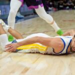 Jan 25, 2026; Minneapolis, Minnesota, USA; Golden State Warriors guard Stephen Curry (30) falls to the court agains the Minnesota Timberwolves in the fourth quarter at Target Center. Mandatory Credit: Matt Blewett-Imagn Images