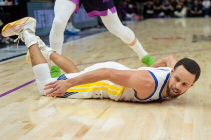 Jan 25, 2026; Minneapolis, Minnesota, USA; Golden State Warriors guard Stephen Curry (30) falls to the court agains the Minnesota Timberwolves in the fourth quarter at Target Center. Mandatory Credit: Matt Blewett-Imagn Images