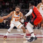 Oct 16, 2025; Atlanta, Georgia, USA; Atlanta Hawks point guard Trae Young (11) dribbles against Houston Rockets guard Aaron Holiday (0) during the first half at State Farm Arena. Mandatory Credit: Dale Zanine-Imagn Images