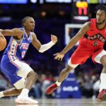 Philadelphia 76ers guard Tyrese Maxey (0) dribbles the ball against Toronto Raptors guard Immanuel Quickley (5) during the first quarter at Xfinity Mobile Arena.