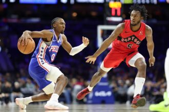 Philadelphia 76ers guard Tyrese Maxey (0) dribbles the ball against Toronto Raptors guard Immanuel Quickley (5) during the first quarter at Xfinity Mobile Arena.