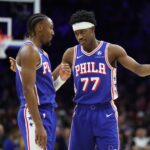 Jan 5, 2026; Philadelphia, Pennsylvania, USA; Philadelphia 76ers guard Vj Edgecombe (77) reacts with guard Tyrese Maxey (0) during the fourth quarter against the Denver Nuggets at Xfinity Mobile Arena. Mandatory Credit: Bill Streicher-Imagn Images