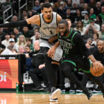 Jan 10, 2026; Boston, Massachusetts, USA; Boston Celtics guard Jaylen Brown (7) drives to the basket against San Antonio Spurs forward Victor Wembanyama (1) during the second half at the TD Garden. Mandatory Credit: Brian Fluharty-Imagn Images