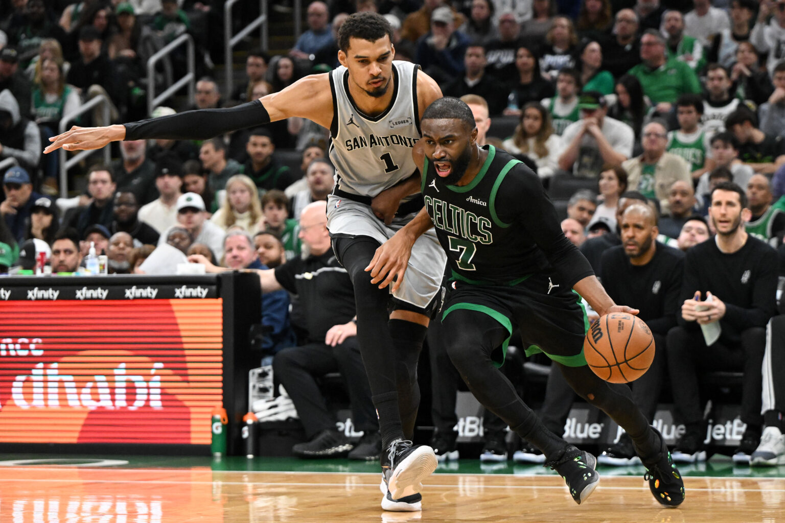 Jan 10, 2026; Boston, Massachusetts, USA; Boston Celtics guard Jaylen Brown (7) drives to the basket against San Antonio Spurs forward Victor Wembanyama (1) during the second half at the TD Garden. Mandatory Credit: Brian Fluharty-Imagn Images