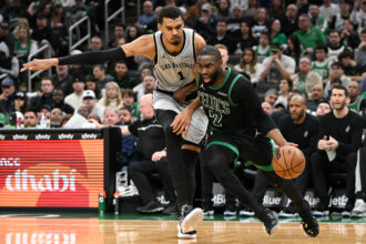 Jan 10, 2026; Boston, Massachusetts, USA; Boston Celtics guard Jaylen Brown (7) drives to the basket against San Antonio Spurs forward Victor Wembanyama (1) during the second half at the TD Garden. Mandatory Credit: Brian Fluharty-Imagn Images