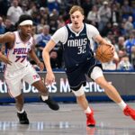 Jan 1, 2026; Dallas, Texas, USA; Dallas Mavericks forward Cooper Flagg (32) drives to the basket past Philadelphia 76ers guard Vj Edgecombe (77) during the first quarter at the American Airlines Center. Mandatory Credit: Jerome Miron-Imagn Images