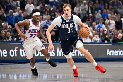 Jan 1, 2026; Dallas, Texas, USA; Dallas Mavericks forward Cooper Flagg (32) drives to the basket past Philadelphia 76ers guard Vj Edgecombe (77) during the first quarter at the American Airlines Center. Mandatory Credit: Jerome Miron-Imagn Images