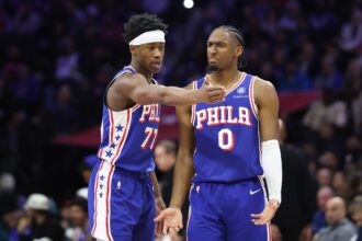 Jan 5, 2026; Philadelphia, Pennsylvania, USA; Philadelphia 76ers guard Vj Edgecombe (77) and guard Tyrese Maxey (0) talk during the third quarter against the Denver Nuggets at Xfinity Mobile Arena. Mandatory Credit: Bill Streicher-Imagn Images