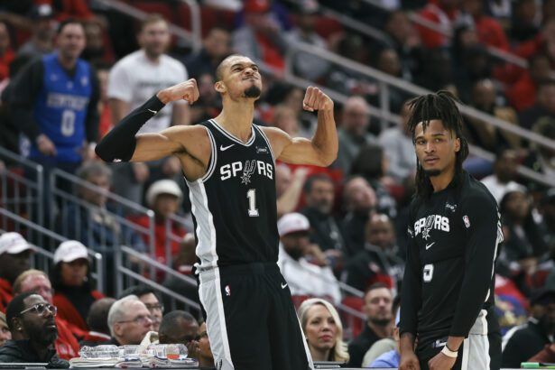 Jan 28, 2026; Houston, Texas, USA; San Antonio Spurs forward Victor Wembanyama (1) and guard Stephon Castle (5) react after a play during the fourth quarter against the Houston Rockets at Toyota Center. Mandatory Credit: Troy Taormina-Imagn Images