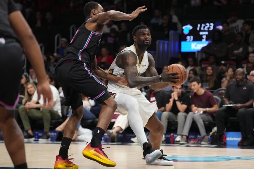 Jan 4, 2026; Miami, Florida, USA; New Orleans Pelicans forward Zion Williamson (1) drives to the basket as Miami Heat forward Andrew Wiggins (22) defends during the second half at Kaseya Center. Mandatory Credit: Jim Rassol-Imagn Images