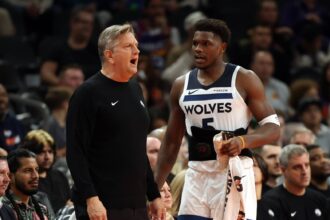 Phoenix, Arizona, USA; Minnesota Timberwolves head coach Chris Finch with guard Anthony Edwards (5) against the Phoenix Suns during an NBA Cup game at Mortgage Matchup Center. Mandatory Credit: Mark J. Rebilas-Imagn Images