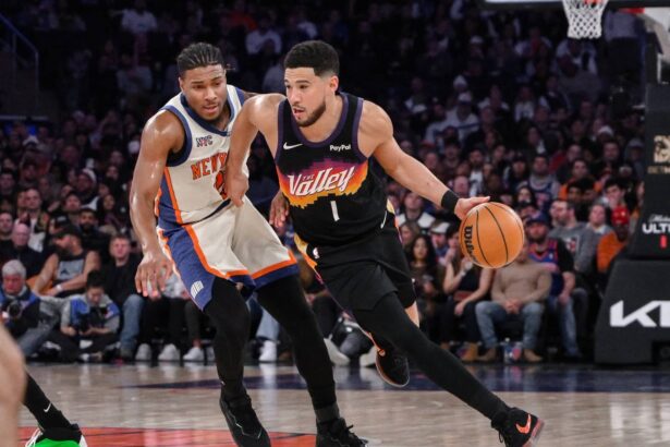 New York, New York, USA; Phoenix Suns guard Devin Booker (1) brings the ball up court while defended by New York Knicks guard Miles McBride (2) during the second half at Madison Square Garden. Mandatory Credit: John Jones-Imagn Images