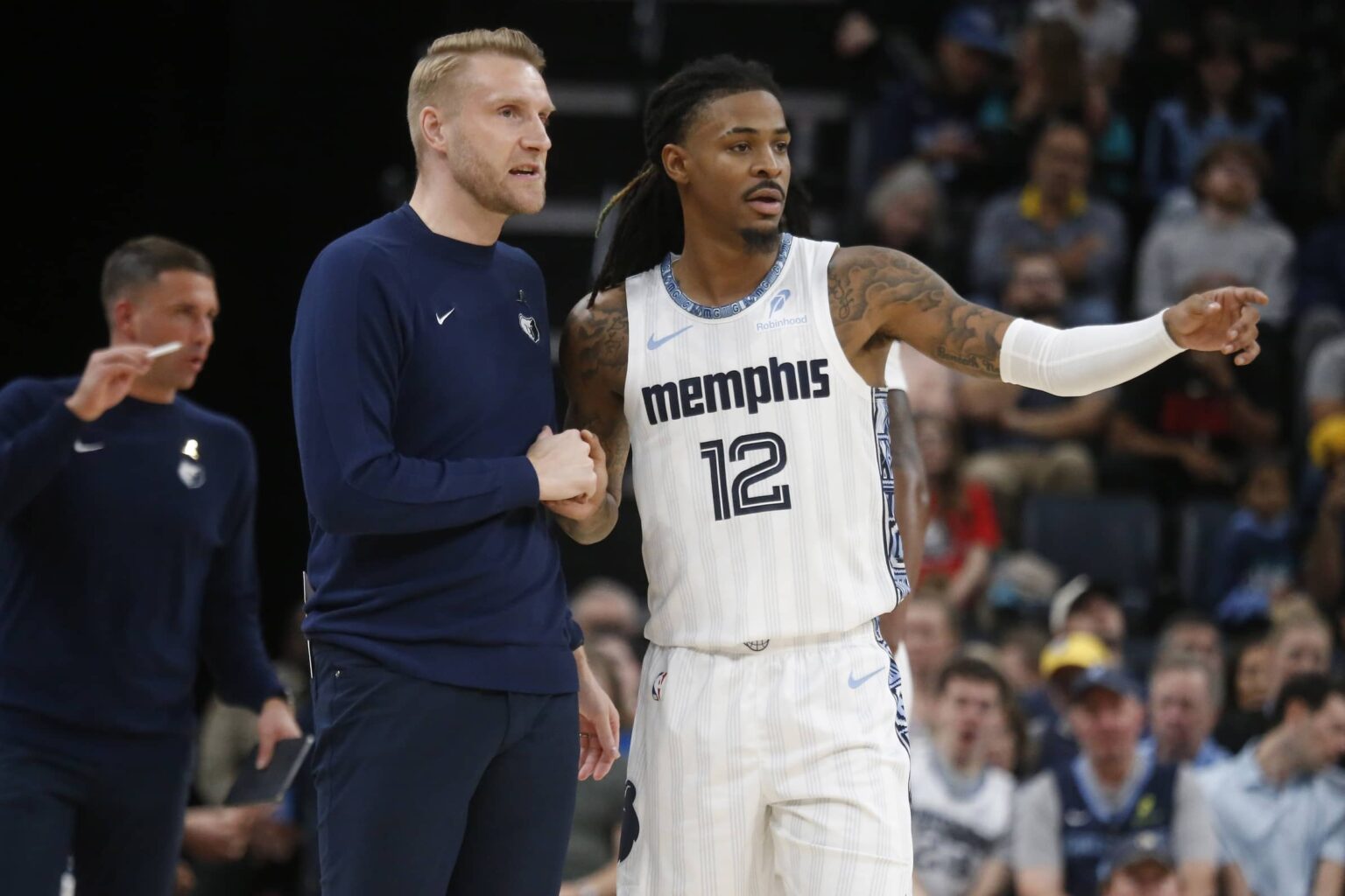 Memphis, Tennessee, USA; Memphis Grizzlies head coach Tuomas Iisalo talks with guard Ja Morant (12) during the fourth quarter against the Milwaukee Bucks at FedExForum. Mandatory Credit: Petre Thomas-Imagn Images