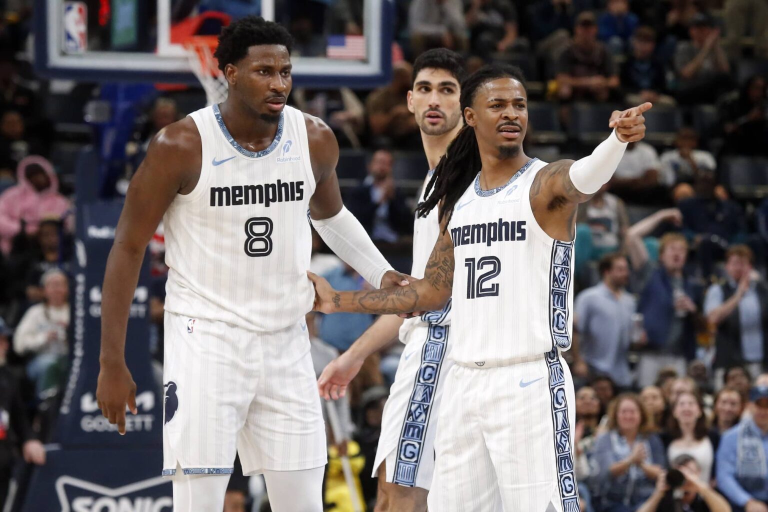 Memphis, Tennessee, USA; Memphis Grizzlies guard Ja Morant (12) reacts with forward/center Jaren Jackson Jr. (8) during the fourth quarter against the Milwaukee Bucks at FedExForum. Mandatory Credit: Petre Thomas-Imagn Images