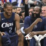 Los Angeles, California, USA; Los Angeles Clippers forward Kawhi Leonard (2) laughs with guard James Harden (1) on the bench in the second half against the Washington Wizards at Crypto.com Arena. Mandatory Credit: Jayne Kamin-Oncea-Imagn Images