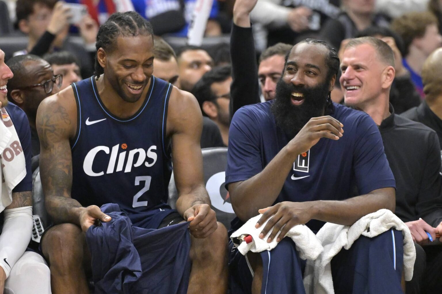 Los Angeles, California, USA; Los Angeles Clippers forward Kawhi Leonard (2) laughs with guard James Harden (1) on the bench in the second half against the Washington Wizards at Crypto.com Arena. Mandatory Credit: Jayne Kamin-Oncea-Imagn Images