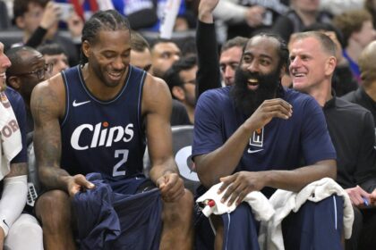 Los Angeles, California, USA; Los Angeles Clippers forward Kawhi Leonard (2) laughs with guard James Harden (1) on the bench in the second half against the Washington Wizards at Crypto.com Arena. Mandatory Credit: Jayne Kamin-Oncea-Imagn Images