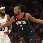Jan 5, 2026; Houston, Texas, USA; Houston Rockets forward Kevin Durant (7) dribbles against Phoenix Suns forward Royce O'Neale (00) in the first quarter at Toyota Center. Mandatory Credit: Thomas Shea-Imagn Images