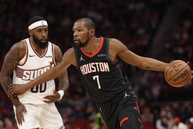 Jan 5, 2026; Houston, Texas, USA; Houston Rockets forward Kevin Durant (7) dribbles against Phoenix Suns forward Royce O'Neale (00) in the first quarter at Toyota Center. Mandatory Credit: Thomas Shea-Imagn Images