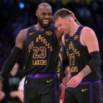 Los Angeles, California, USA; Los Angeles Lakers forward LeBron James (23) and Los Angeles Lakers guard Luka Doncic (77) walk to the bench during a time out in the second half at Crypto.com Arena. Mandatory Credit: Jayne Kamin-Oncea-Imagn Images