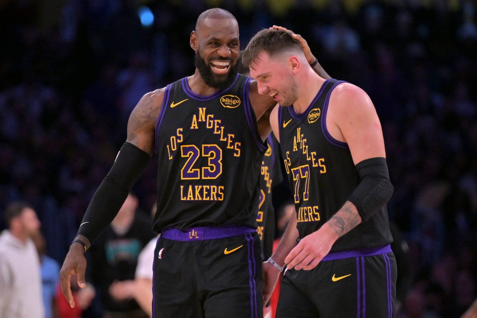 Los Angeles, California, USA; Los Angeles Lakers forward LeBron James (23) and Los Angeles Lakers guard Luka Doncic (77) walk to the bench during a time out in the second half at Crypto.com Arena. Mandatory Credit: Jayne Kamin-Oncea-Imagn Images