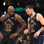 Washington, District of Columbia, USA; Los Angeles Lakers forward/guard Luka Doncic (77) talks with Los Angeles Lakers forward LeBron James (23) against the Washington Wizards during the second half at Capital One Arena. Mandatory Credit: Brad Mills-Imagn Images