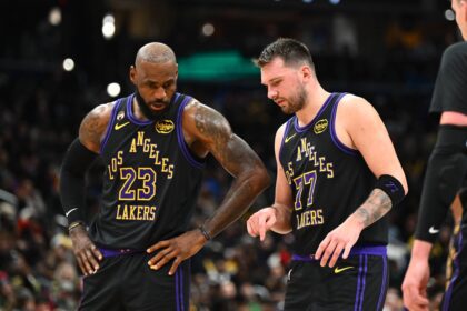 Washington, District of Columbia, USA; Los Angeles Lakers forward/guard Luka Doncic (77) talks with Los Angeles Lakers forward LeBron James (23) against the Washington Wizards during the second half at Capital One Arena. Mandatory Credit: Brad Mills-Imagn Images