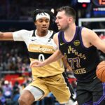 Washington, District of Columbia, USA; Los Angeles Lakers forward/guard Luka Doncic (77) dribbles as Washington Wizards guard Bilal Coulibaly (0) defends during the second half at Capital One Arena. Mandatory Credit: Brad Mills-Imagn Images