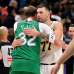 Dallas, Texas, USA; Dallas Mavericks forward Cooper Flagg (32) hugs Los Angeles Lakers guard Luka Doncic (77) after the game at the American Airlines Center. Mandatory Credit: Jerome Miron-Imagn Images