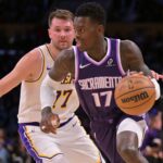 Los Angeles, California, USA; Sacramento Kings guard Dennis Schroder (17) drives past Los Angeles Lakers guard Luka Doncic (77) in the first half at Crypto.com Arena. Mandatory Credit: Jayne Kamin-Oncea-Imagn Images