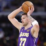 Chicago, Illinois, USA; Los Angeles Lakers guard Luka Doncic (77) looks to pass the ball against the Chicago Bulls during the second half at United Center. Mandatory Credit: Kamil Krzaczynski-Imagn Images