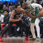 Toronto, Ontario, CAN; Boston Celtics forward Jaylen Brown (7) controls the ball against Toronto Raptors guard Scottie Barnes (4) during the second half at Scotiabank Arena. Mandatory Credit: John E. Sokolowski-Imagn Images