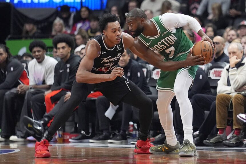 Toronto, Ontario, CAN; Boston Celtics forward Jaylen Brown (7) controls the ball against Toronto Raptors guard Scottie Barnes (4) during the second half at Scotiabank Arena. Mandatory Credit: John E. Sokolowski-Imagn Images