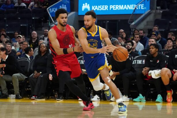 San Francisco, California, USA; Golden State Warriors guard Stephen Curry (30) dribbles by Portland Trail Blazers forward Toumani Camara (33) in the third quarter at Chase Center. Mandatory Credit: David Gonzales-Imagn Images