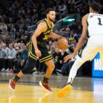 San Francisco, California, USA; Golden State Warriors guard Stephen Curry (30) dribbles the basketball against San Antonio Spurs center Victor Wembanyama (1) during the fourth quarter at Chase Center. Mandatory Credit: Kyle Terada-Imagn Images