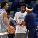 New Orleans, Louisiana, USA; Denver Nuggets guard/forward Bruce Brown (11) talks with New Orleans Pelicans forward Herbert Jones (2) and forward Trey Murphy III (25) during warmups at Smoothie King Center. Mandatory Credit: Stephen Lew-Imagn Images