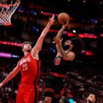 Mar 15, 2025; Houston, Texas, USA; Chicago Bulls guard Coby White (0) drives to the basket against Houston Rockets center Alperen Sengun (28) during the second quarter at Toyota Center. Mandatory Credit: Erik Williams-Imagn Images
