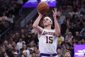 Nov 23, 2025; Salt Lake City, Utah, USA; Los Angeles Lakers guard Austin Reaves (15) takes a shot at the buzzer against the Utah Jazz to end the first half at Delta Center. Mandatory Credit: Rob Gray-Imagn Images