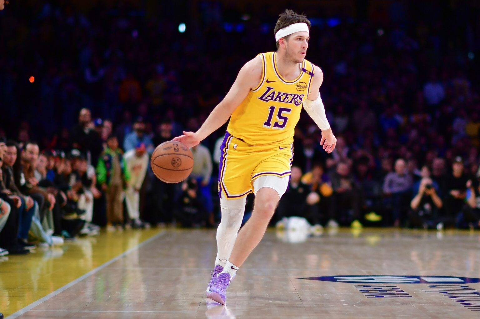 Mar 6, 2025; Los Angeles, California, USA; Los Angeles Lakers guard Austin Reaves (15) moves the ball against the New York Knicks during the second half at Crypto.com Arena. Mandatory Credit: Gary A. Vasquez-Imagn Images