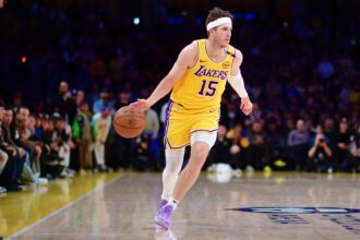 Mar 6, 2025; Los Angeles, California, USA; Los Angeles Lakers guard Austin Reaves (15) moves the ball against the New York Knicks during the second half at Crypto.com Arena. Mandatory Credit: Gary A. Vasquez-Imagn Images