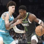 Mar 5, 2025; Charlotte, North Carolina, USA; Minnesota Timberwolves guard Anthony Edwards (5) drives past Charlotte Hornets guard LaMelo Ball (1) during the second half at the Spectrum Center. Mandatory Credit: Sam Sharpe-Imagn Images
