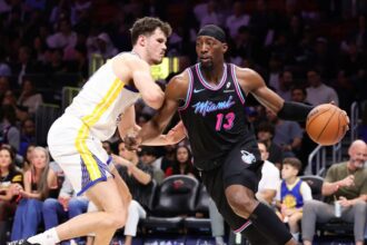 Bam Adebayo drives past Quinten Post during a game against the Golden State Warriors. Mandatory Credit: Megan Briggs - Getty Images