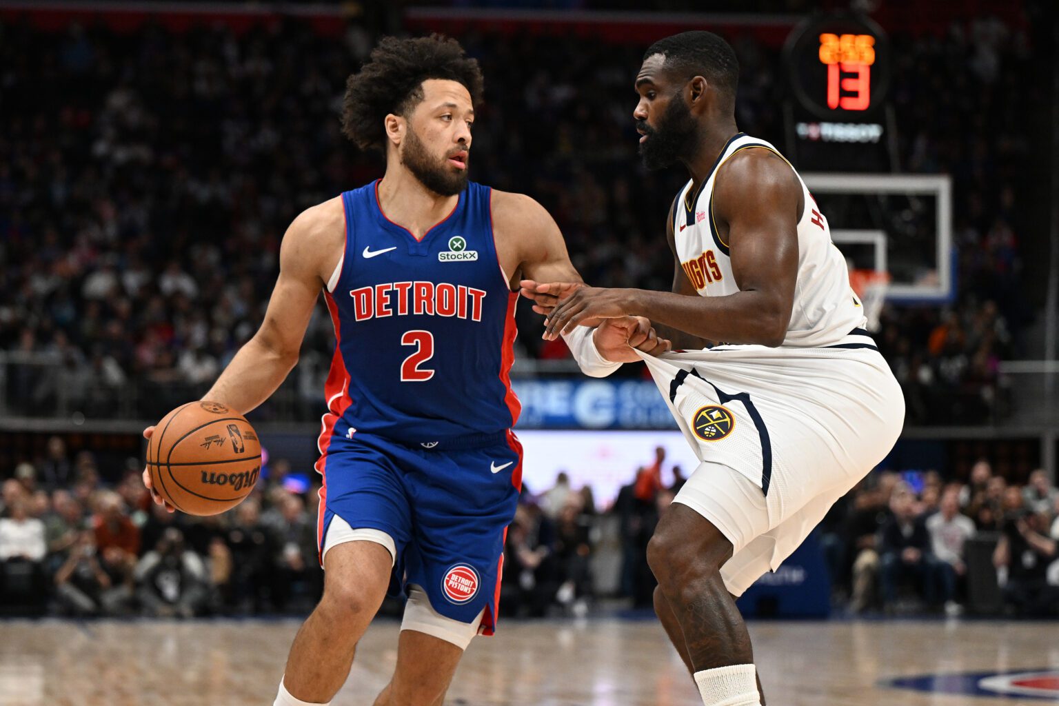 Feb 3, 2026; Detroit, Michigan, USA; Detroit Pistons guard Cade Cunningham (2) tugs on the shorts of Denver Nuggets guard Tim Hardaway Jr. (10) before trying to drive past him in the second quarter at Little Caesars Arena. Mandatory Credit: Lon Horwedel-Imagn Images